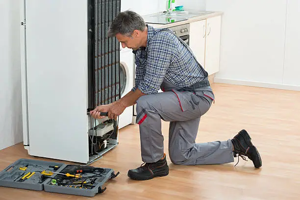man fixing home appliance